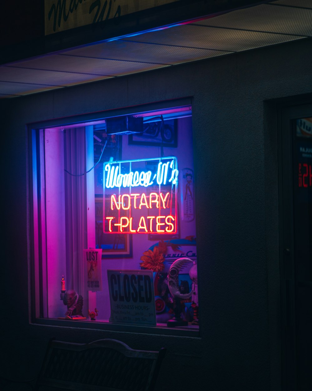 a neon sign in the window of a store