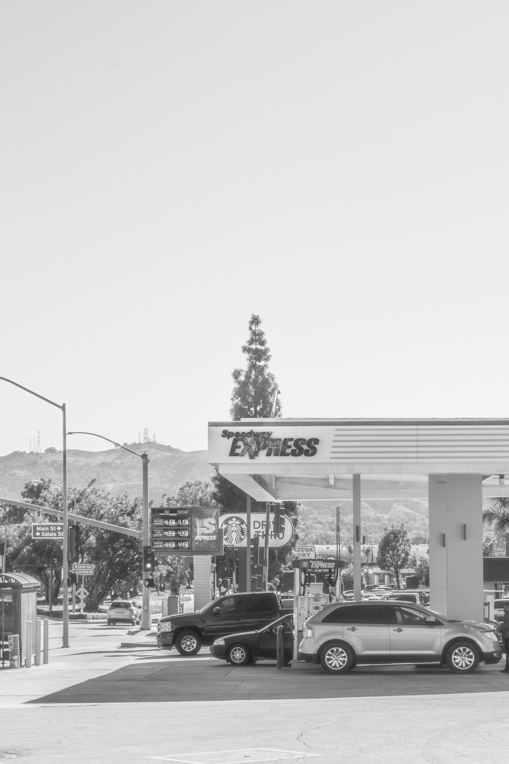 a black and white photo of a gas station