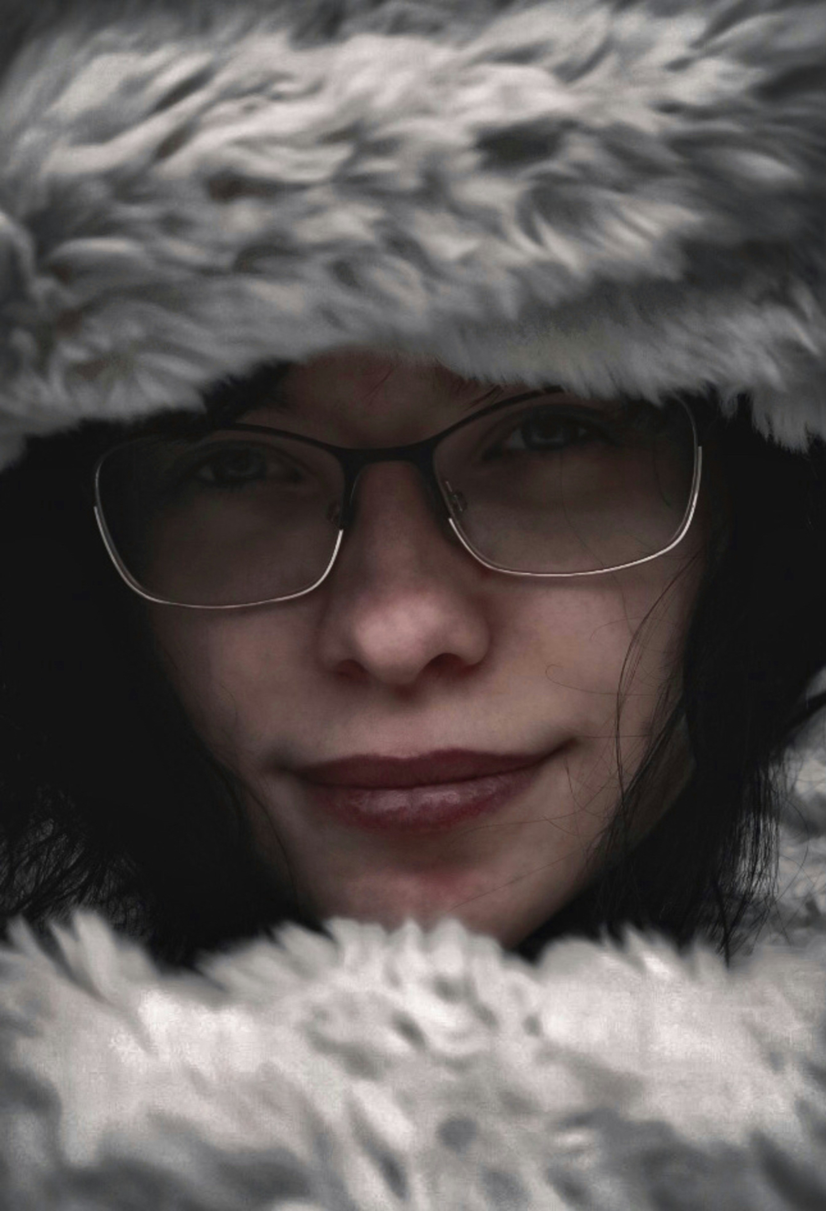 a woman wearing glasses and a fur coat