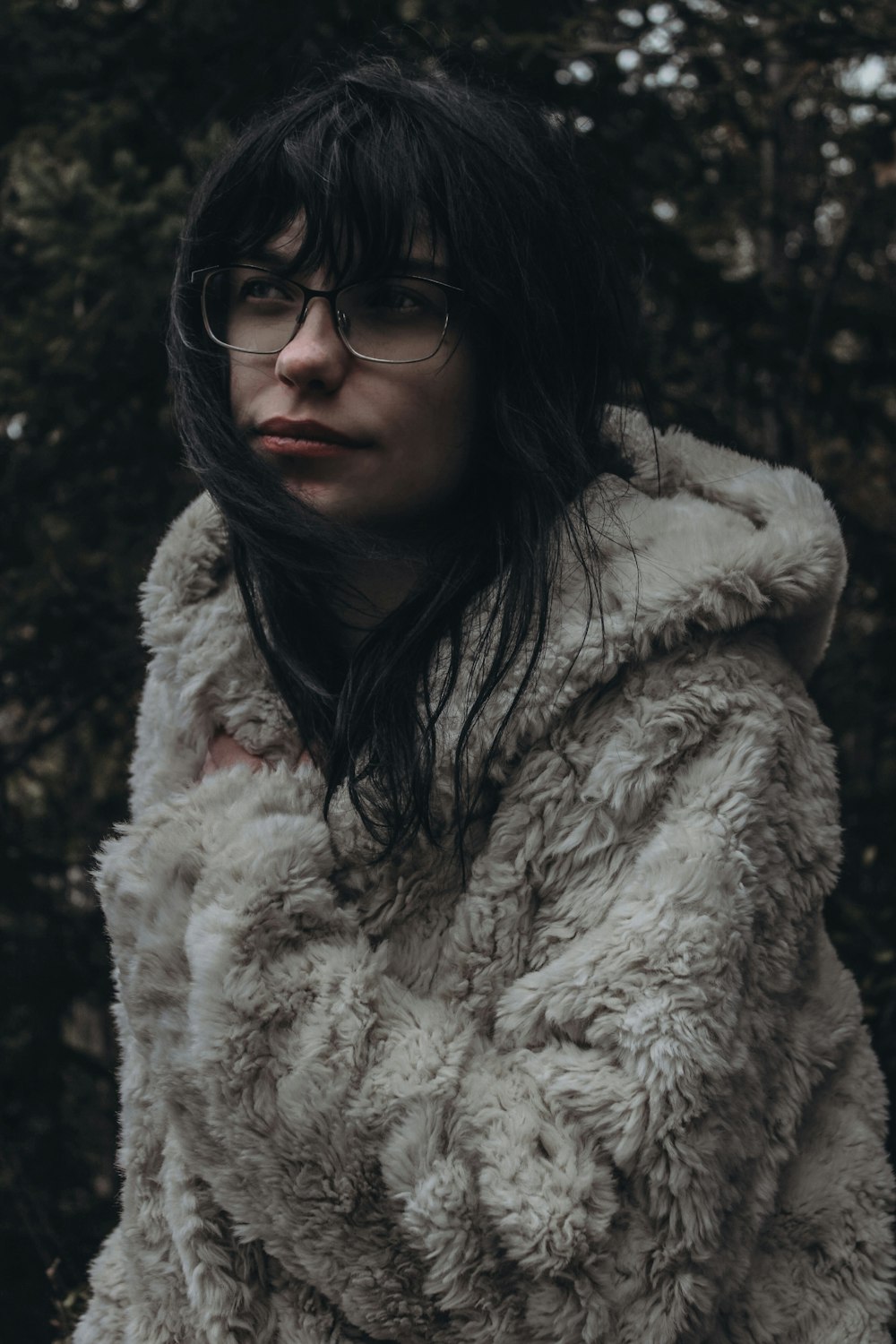 a woman wearing glasses and a fur coat