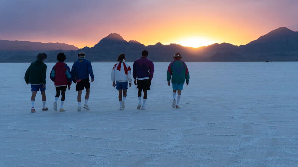 a group of people standing in the middle of a desert