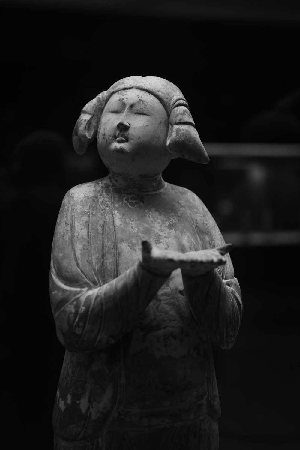 a statue of a person holding a plate