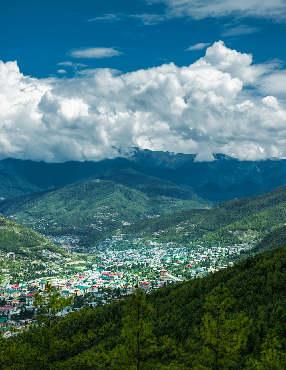 a scenic view of a city in the mountains