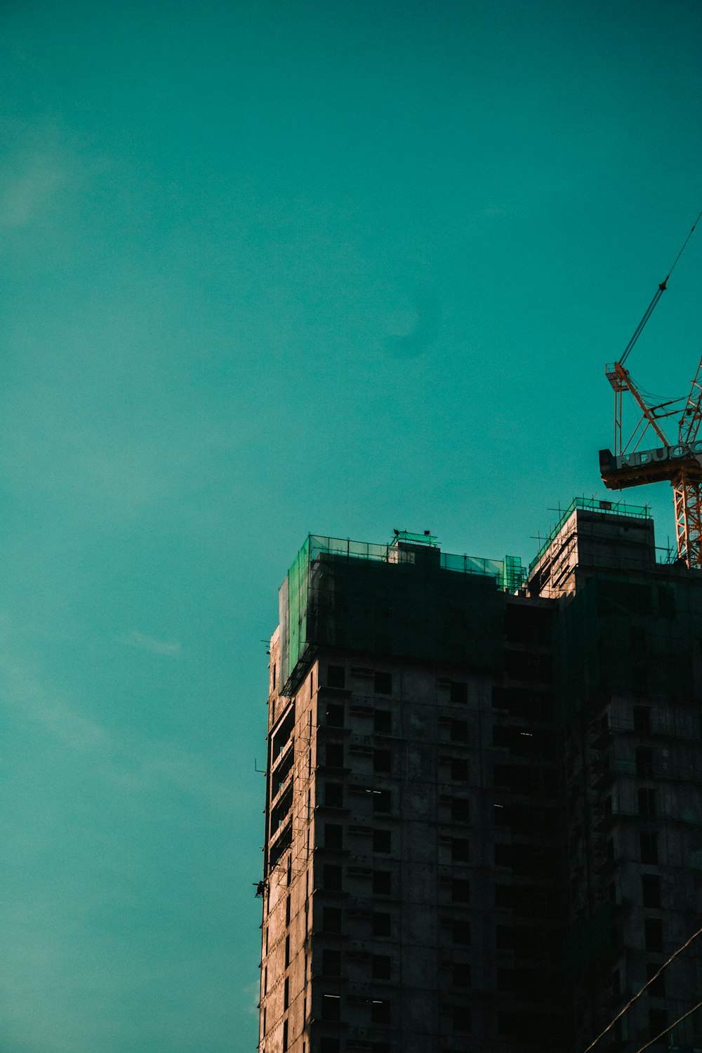 a tall building with a crane on top of it