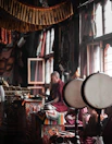 a person sitting in a room with a drum