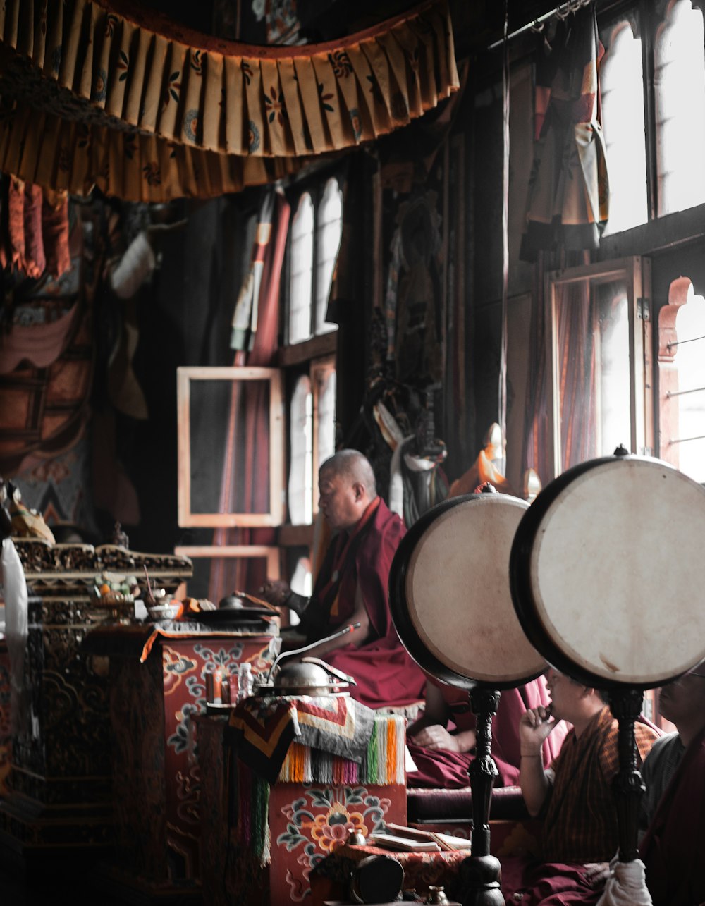 a person sitting in a room with a drum