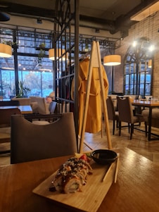 Cozy interior of Joe Sushi restaurant with beautifully arranged sushi plates on wooden tables.