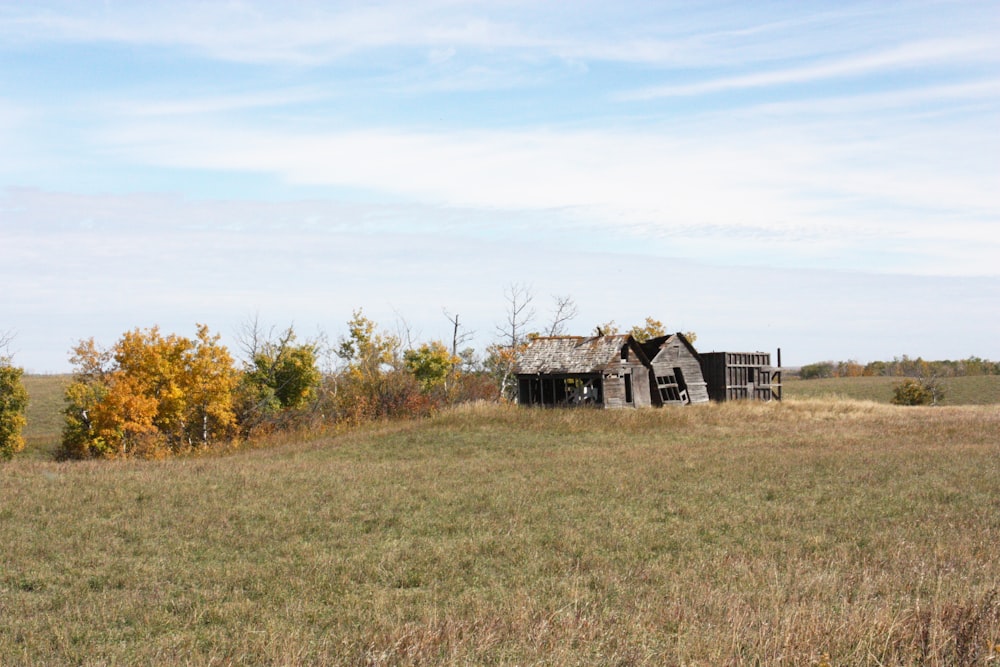 an old run down house in a field