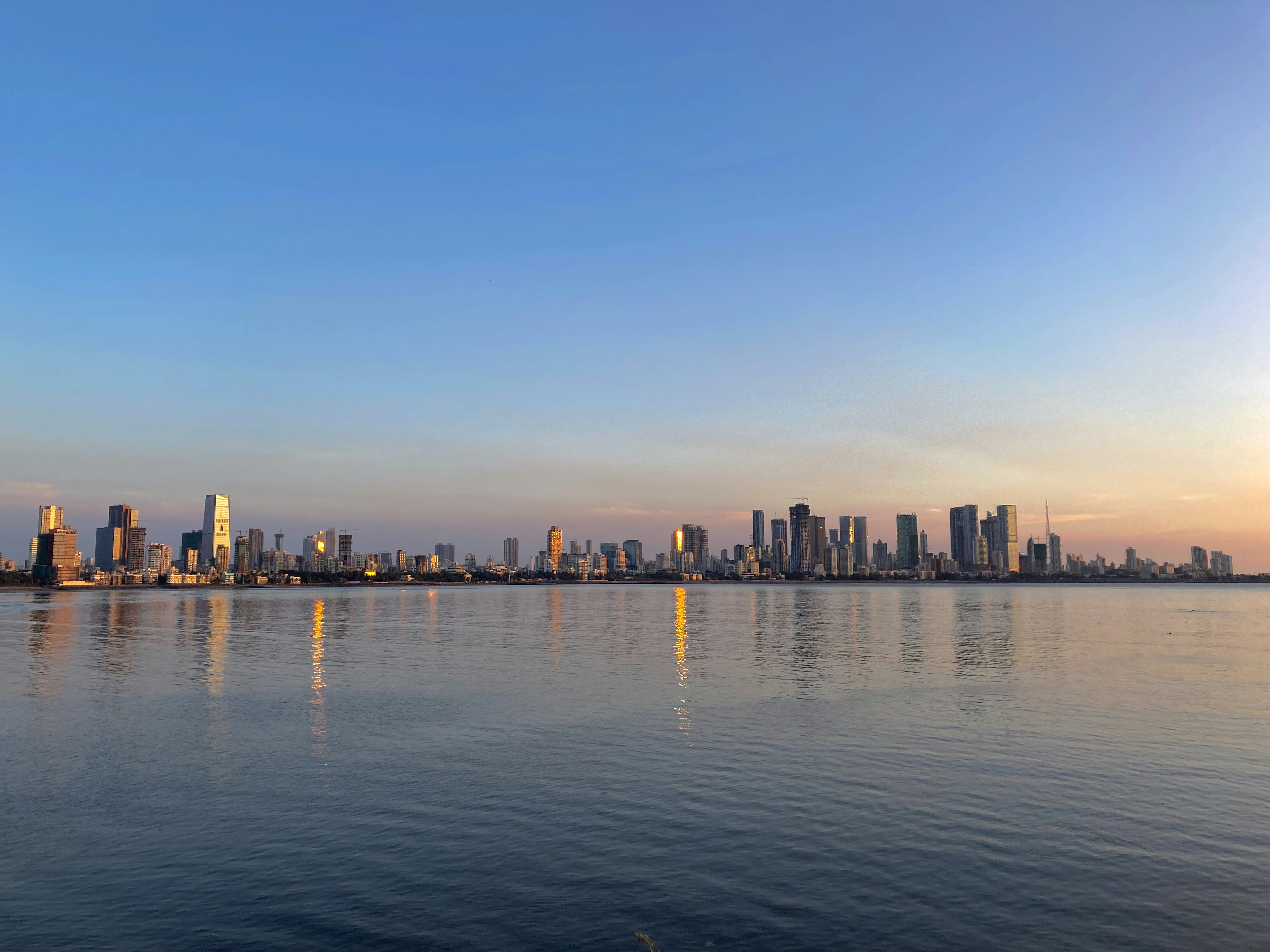 a large body of water with a city in the background