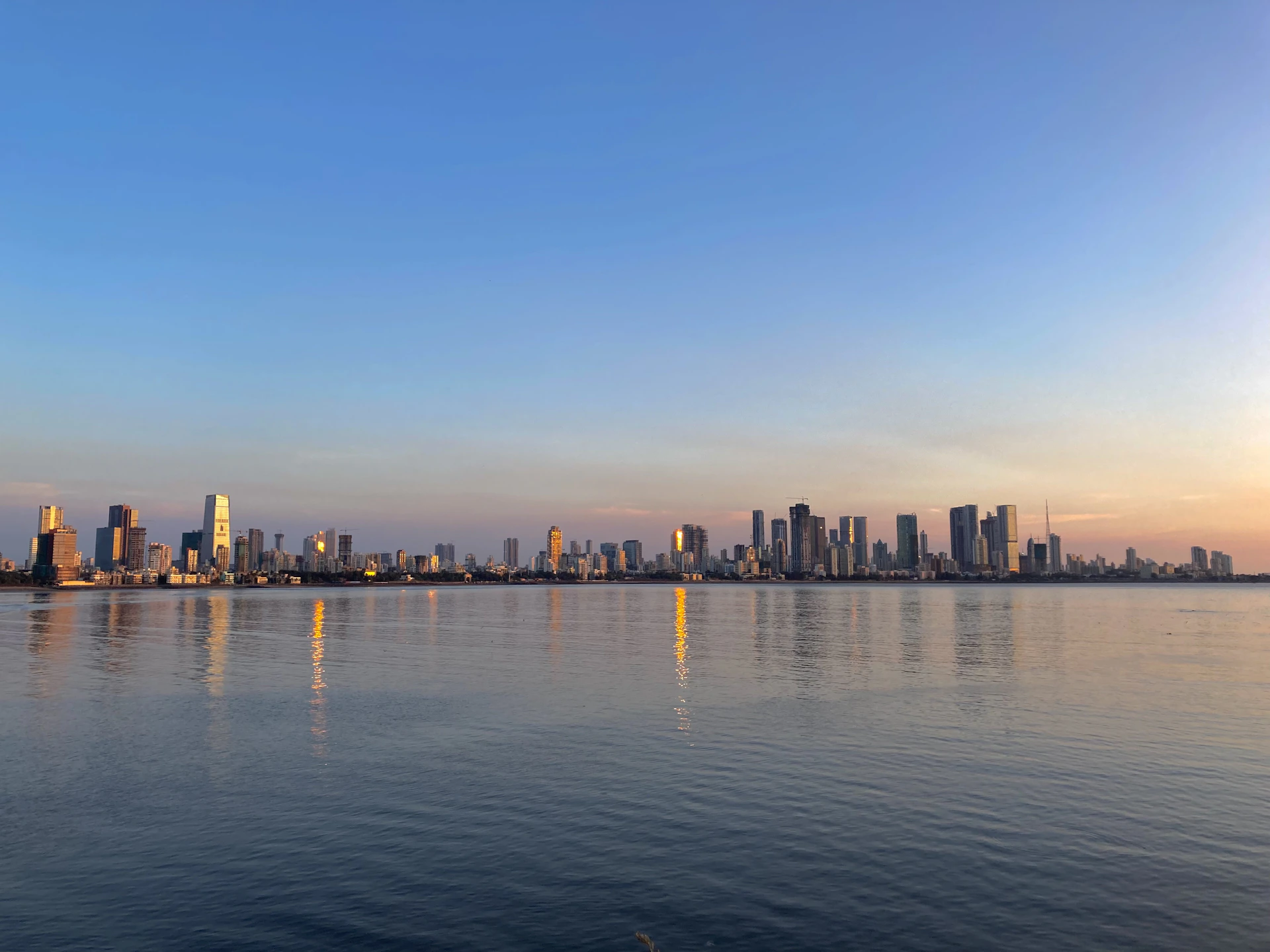 a large body of water with a city in the background