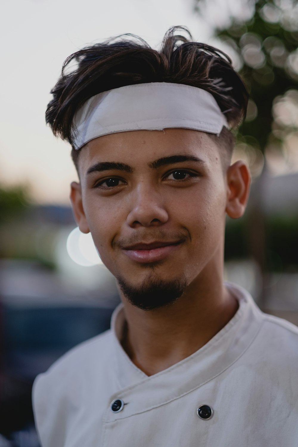 a man with a white headband and a white shirt