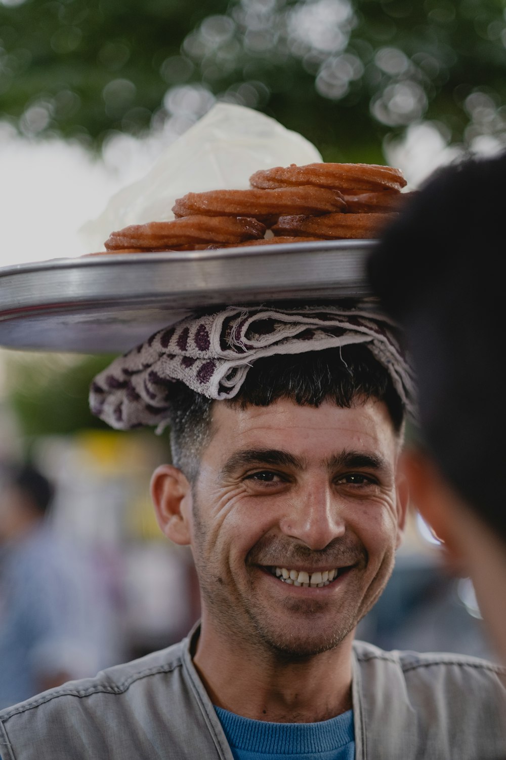 a man with a tray of food on his head