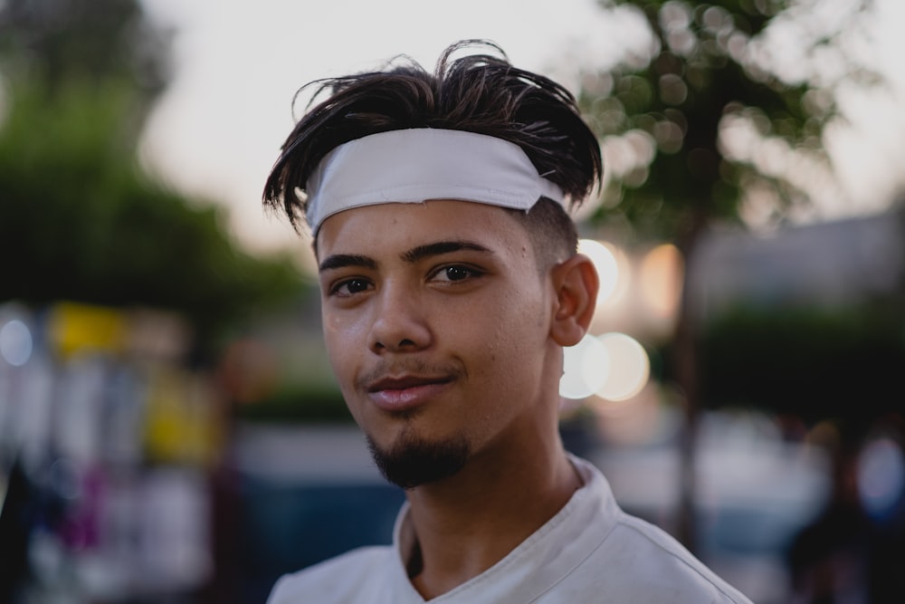 a man with a headband on standing in the street