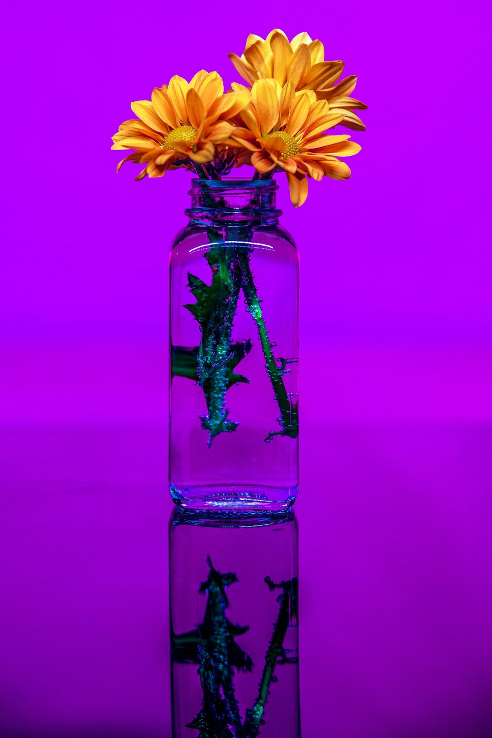 a vase filled with yellow flowers on top of a table