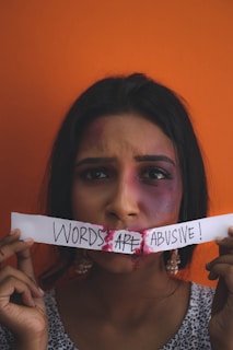 a woman holding a piece of paper with words on it