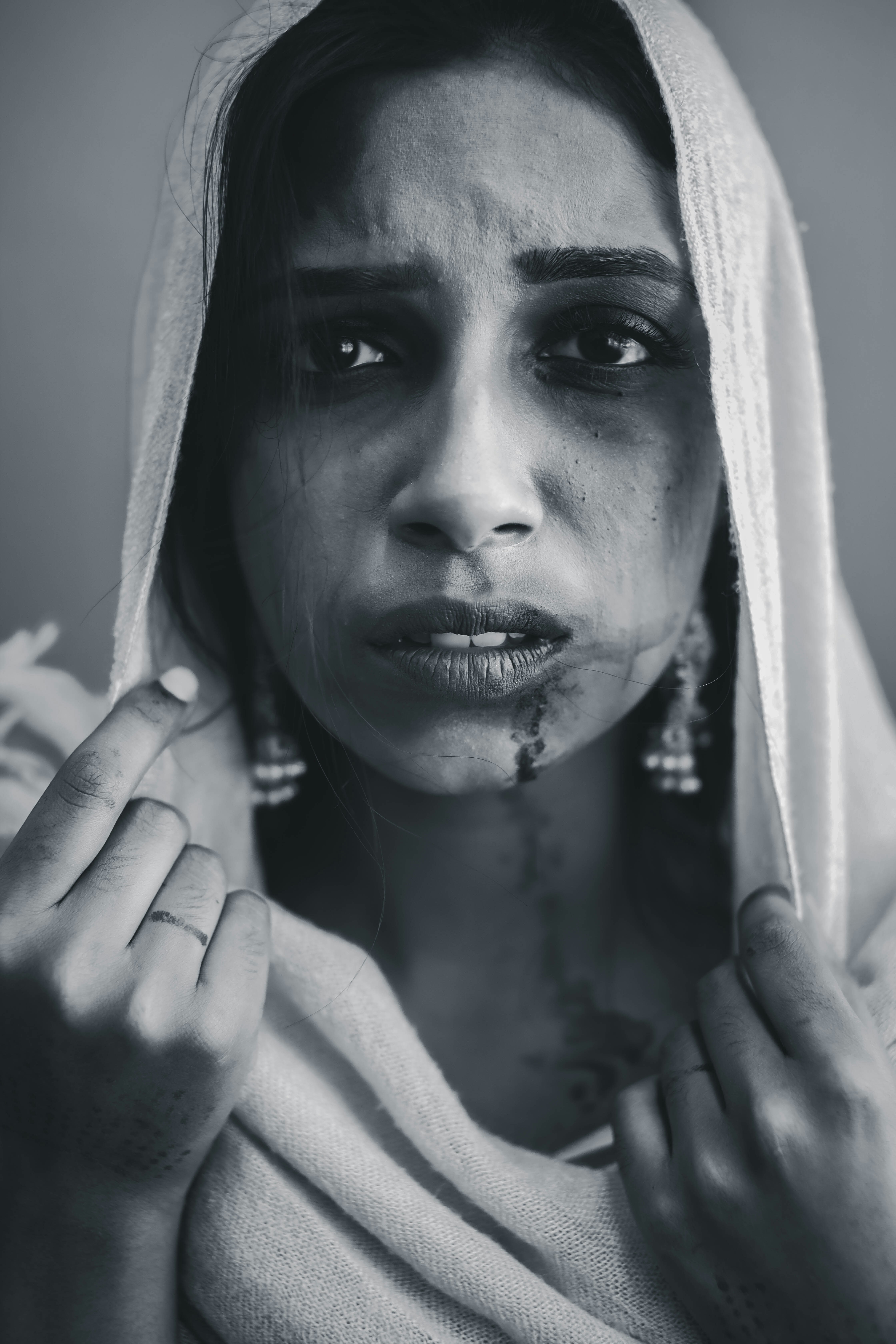 a woman with makeup on her face and a towel over her head