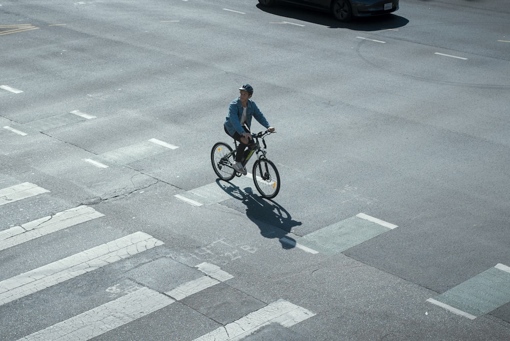 a man riding a bike across a street