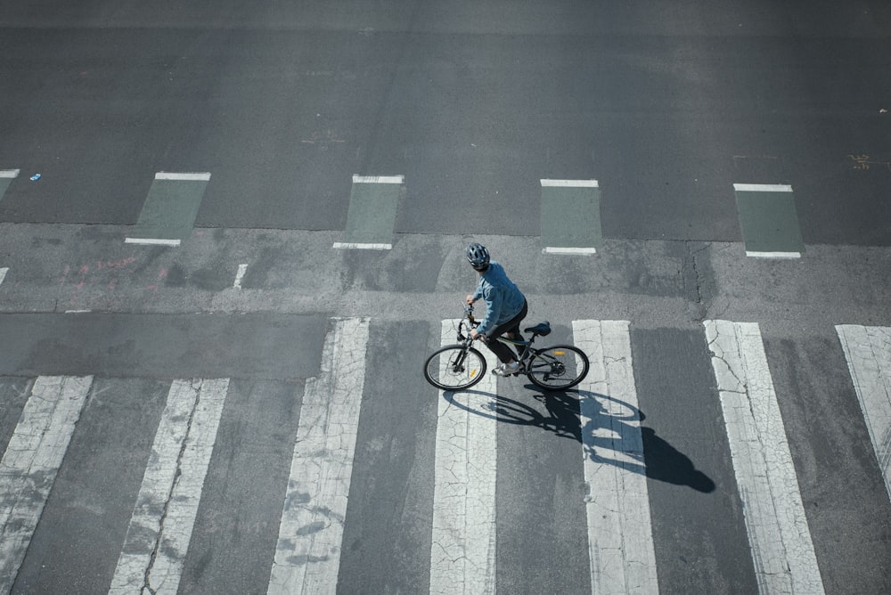 a person riding a bike across a street