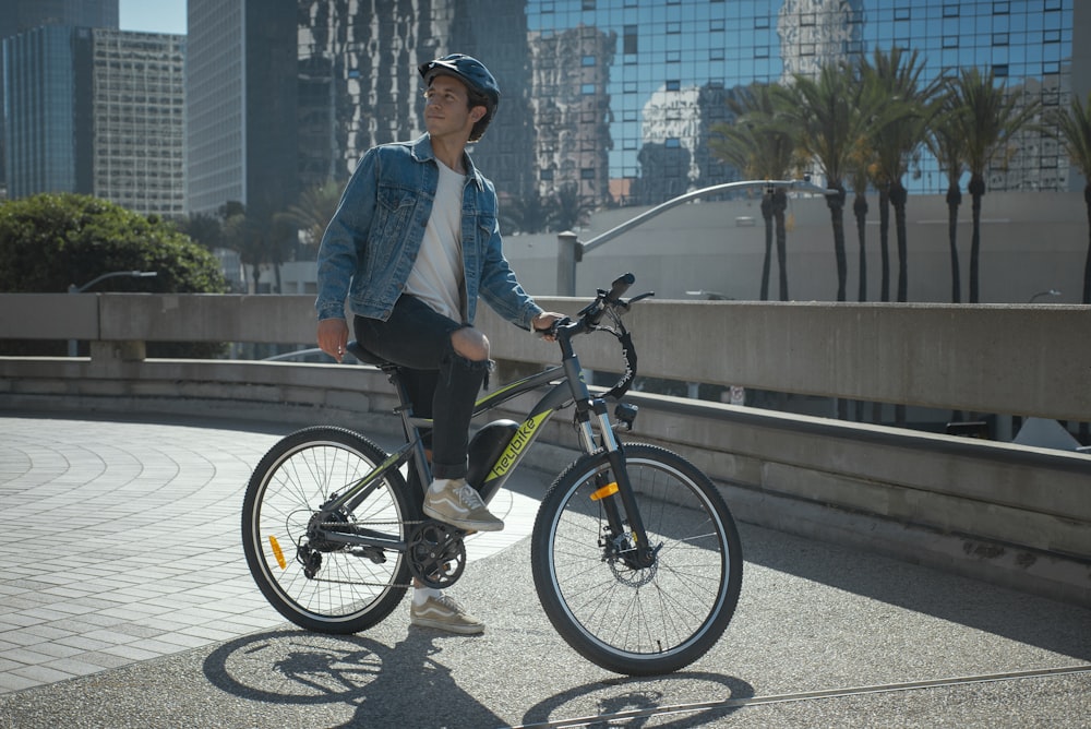 a man standing next to a bike on a bridge