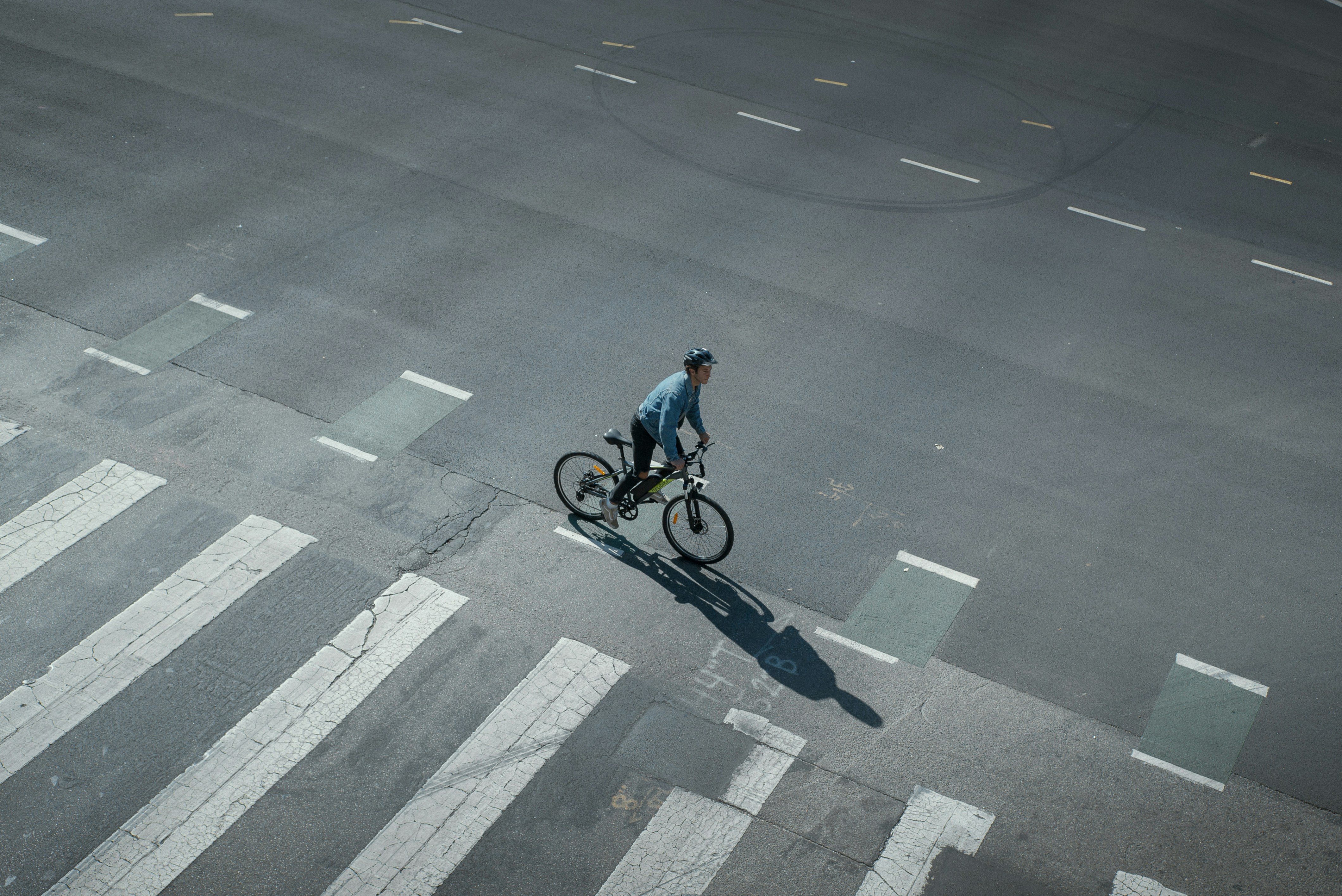 a man riding a bike down a street