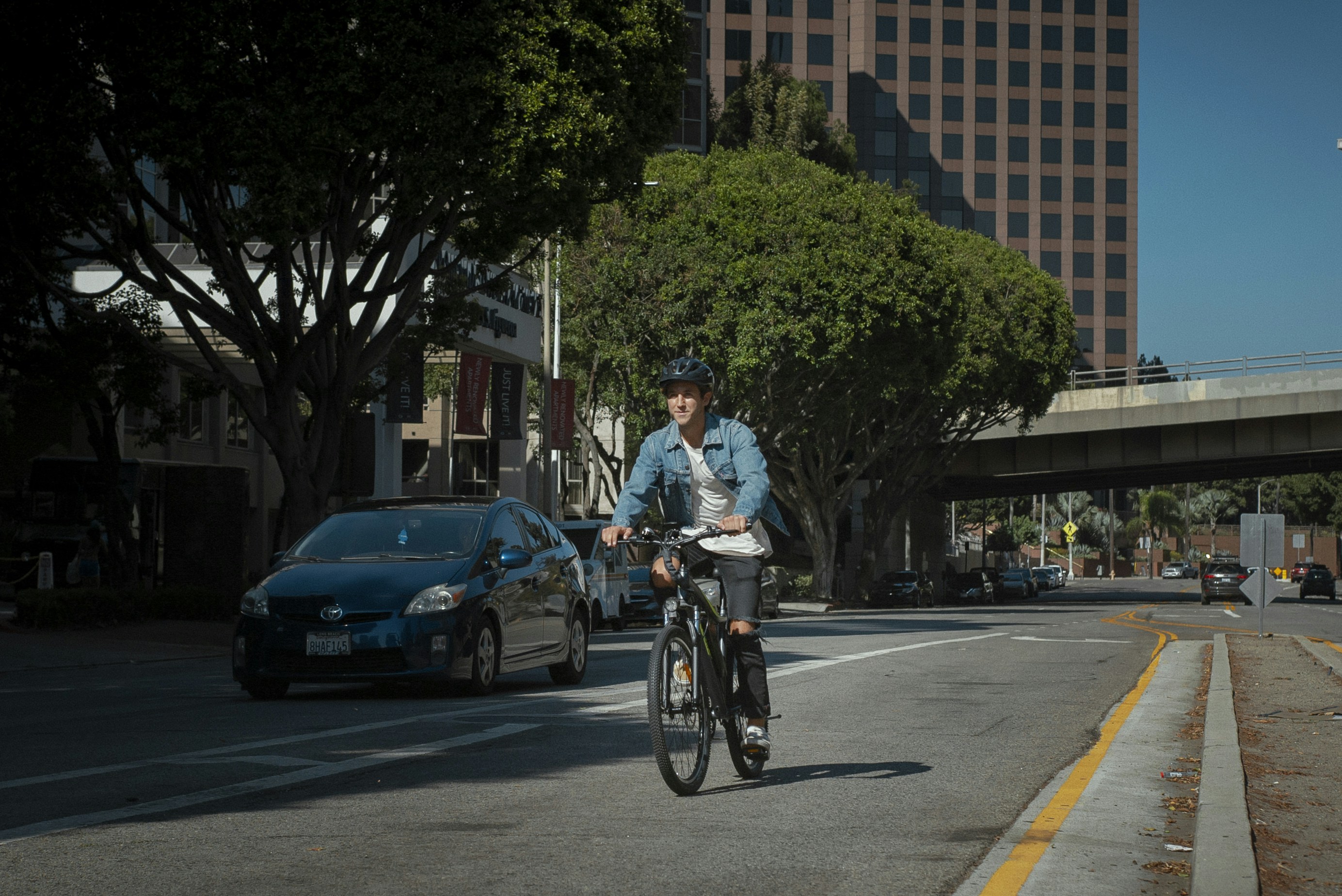 a man riding a bike down the middle of a street