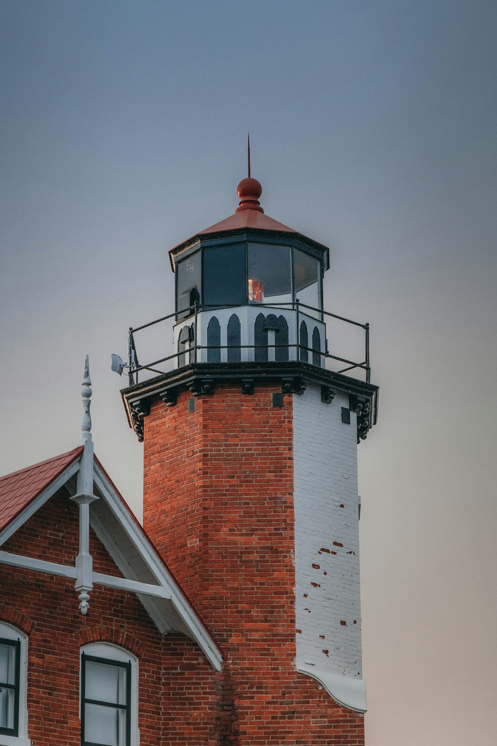 a red brick building with a light house on top