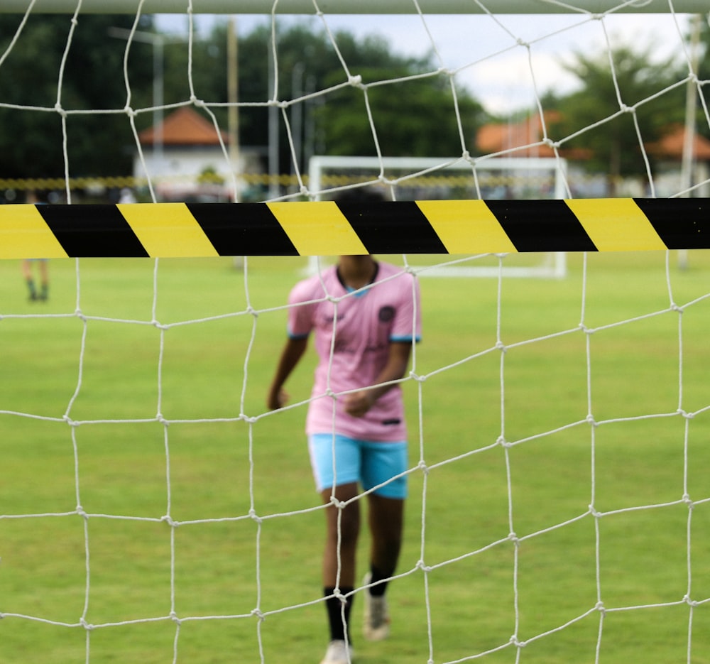 a man standing in front of a soccer net