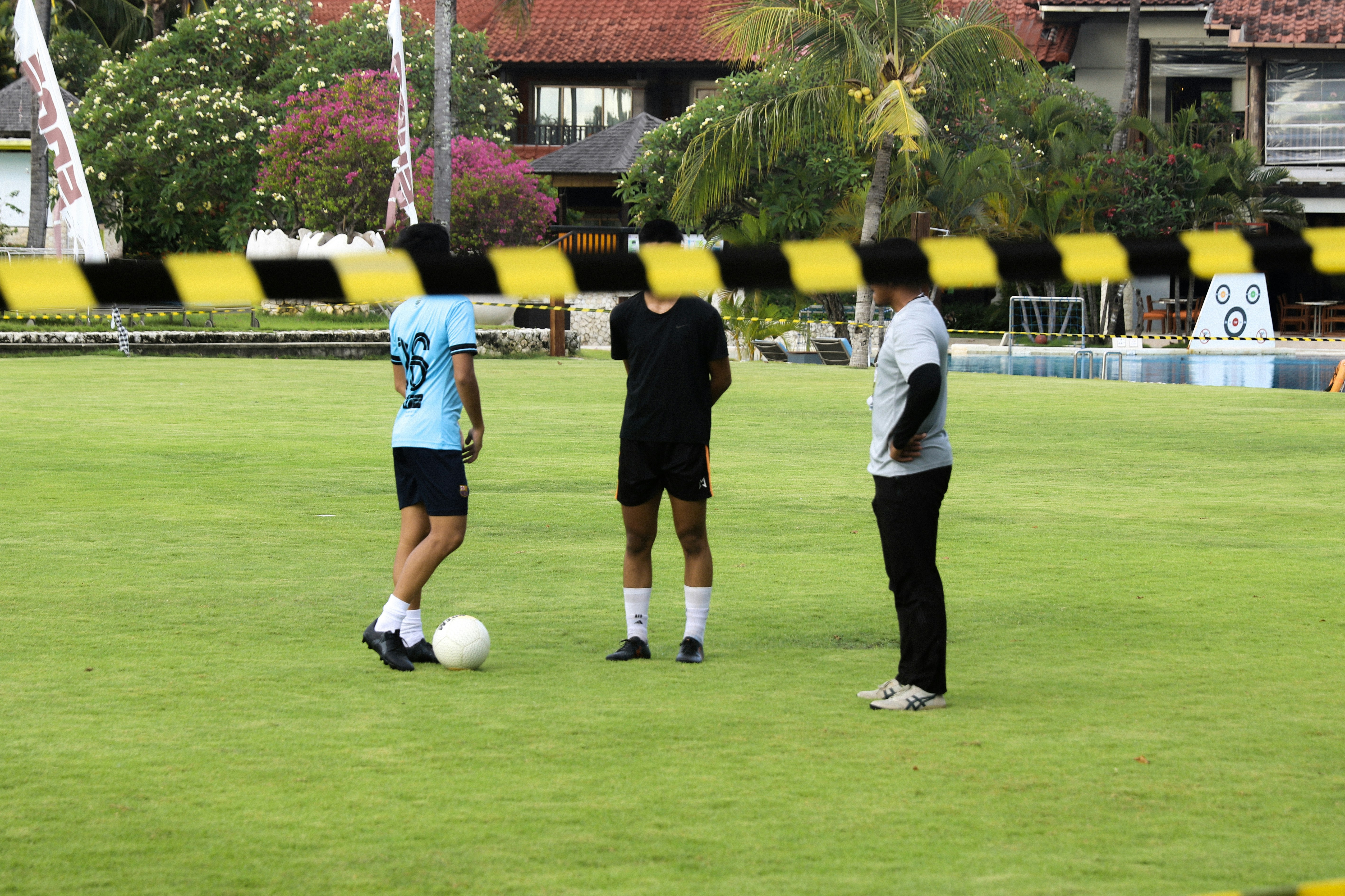 a group of people standing around a soccer ball