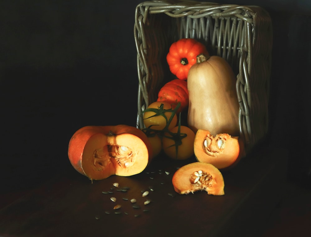 a painting of pumpkins and squash in a basket