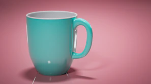 Close-up of a vibrant turquoise ceramic mug with a smooth matte finish.