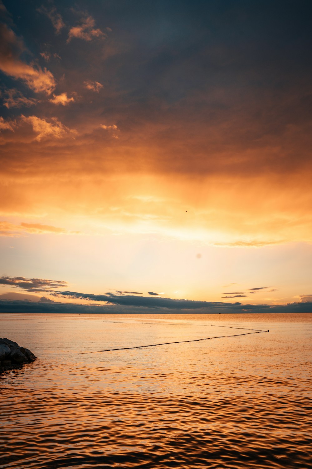 a boat is out on the water at sunset