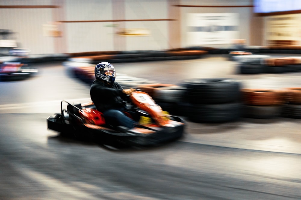 a person riding a go kart in a race track