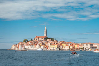 a boat in the water with a city in the background