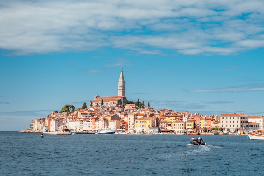 a boat in the water with a city in the background