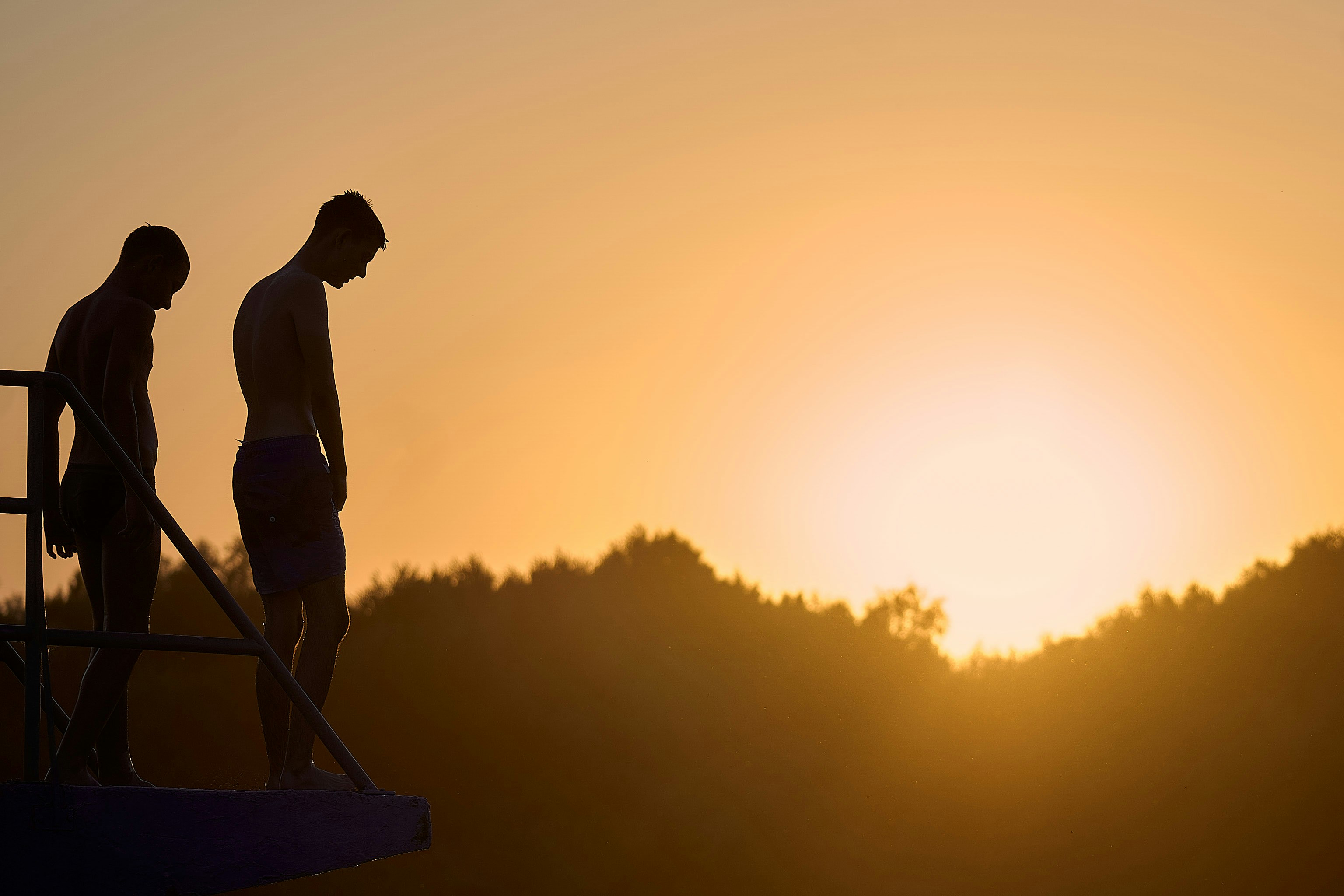 A couple of men standing on top of a boat photo – Free Brown Image on ...