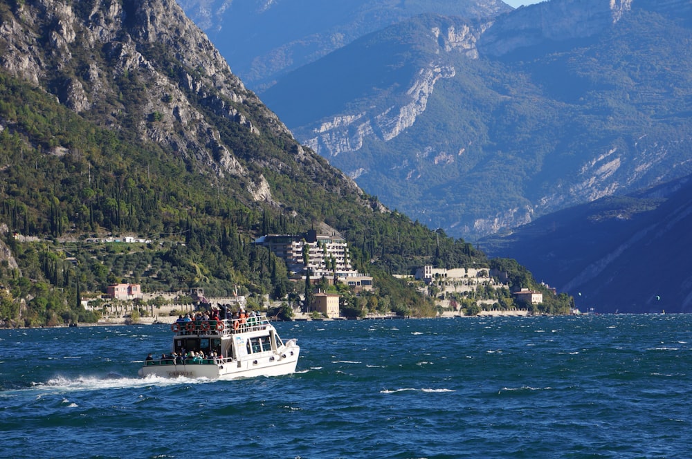 a boat traveling on a body of water near mountains