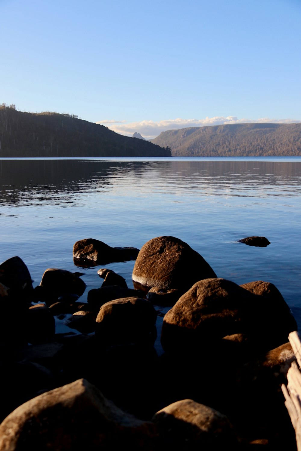 a body of water surrounded by rocks and mountains