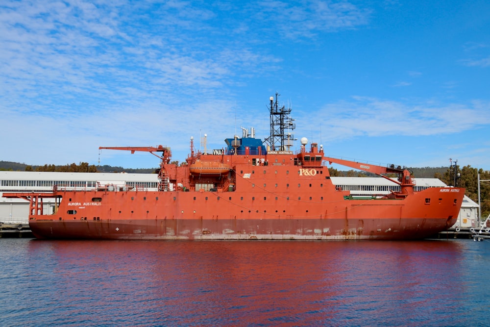 a large orange boat in a body of water