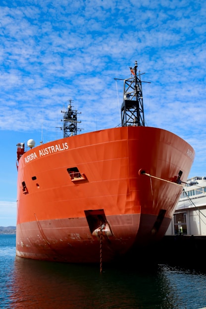 a large orange boat docked at a dock