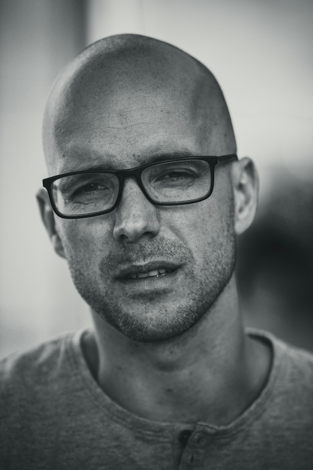 a black and white photo of a man wearing glasses