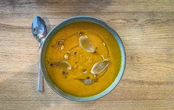 a bowl of soup on a wooden table