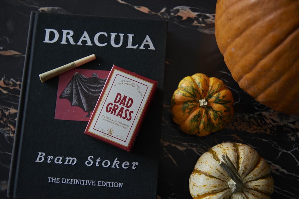 a book sitting on top of a table next to pumpkins