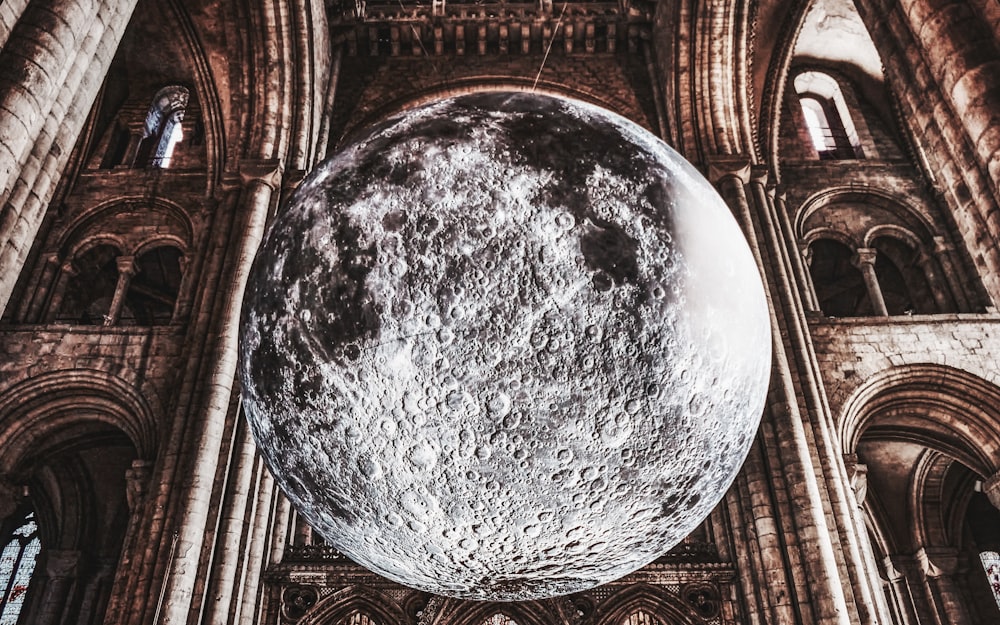 a giant moon is in the middle of a cathedral