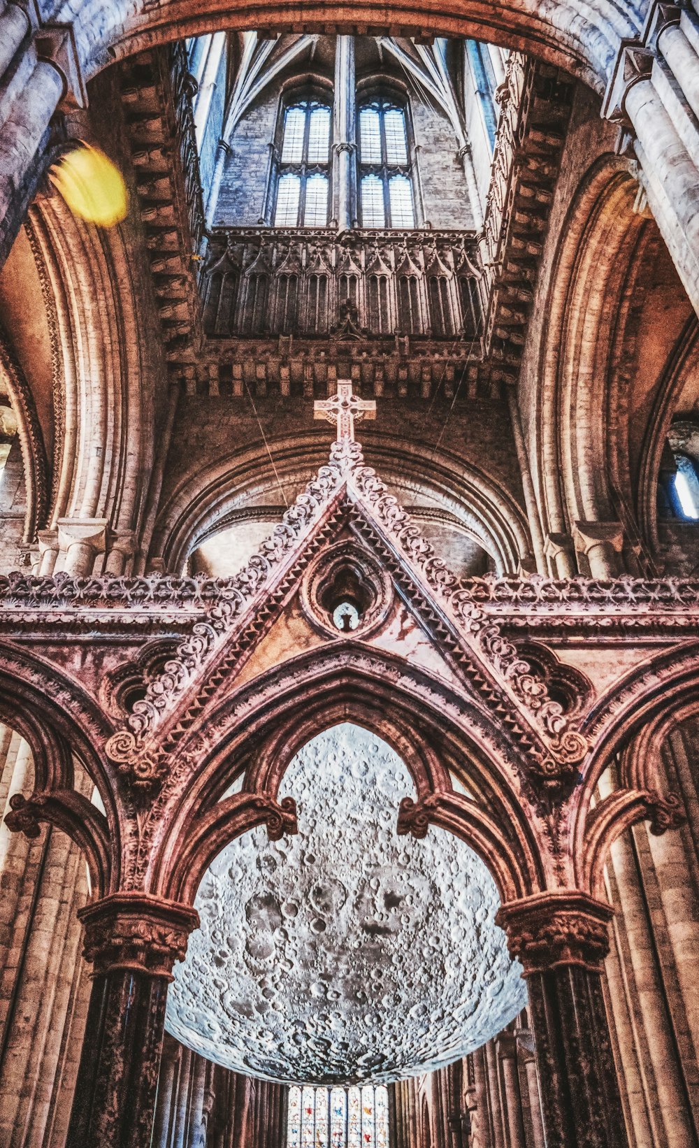 a large cathedral with a cross hanging from the ceiling