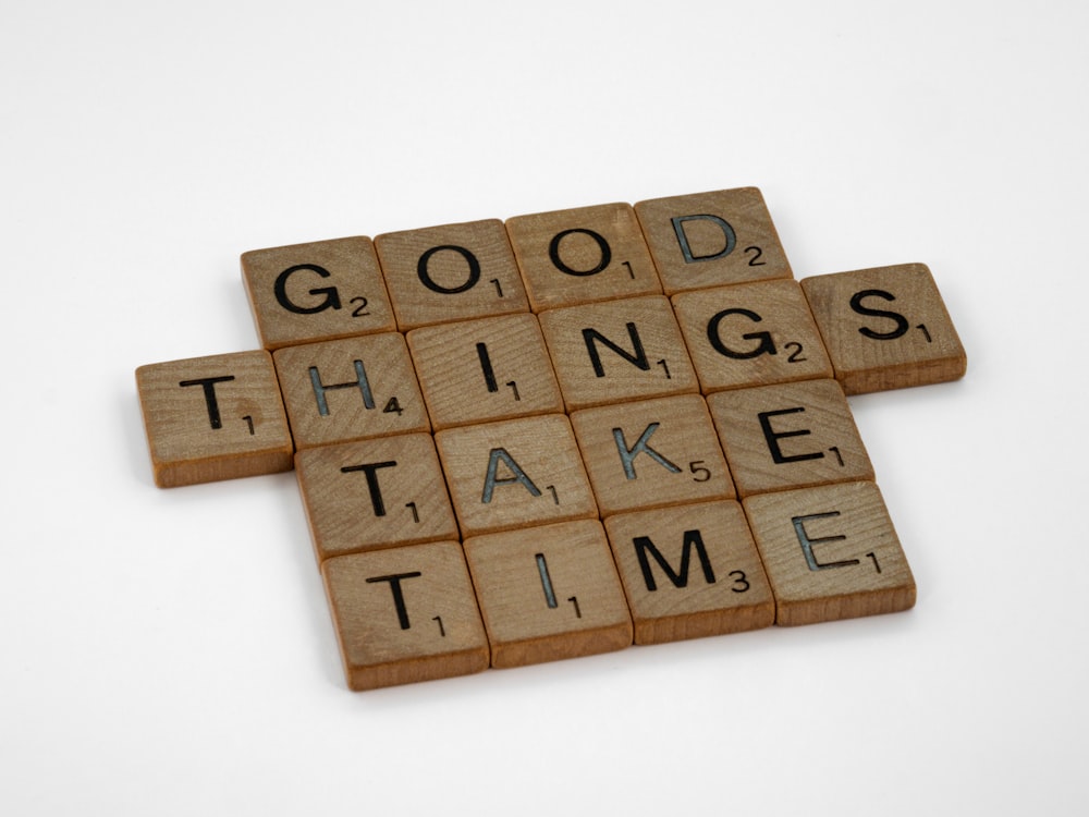scrabble tiles spelling the words good things take time