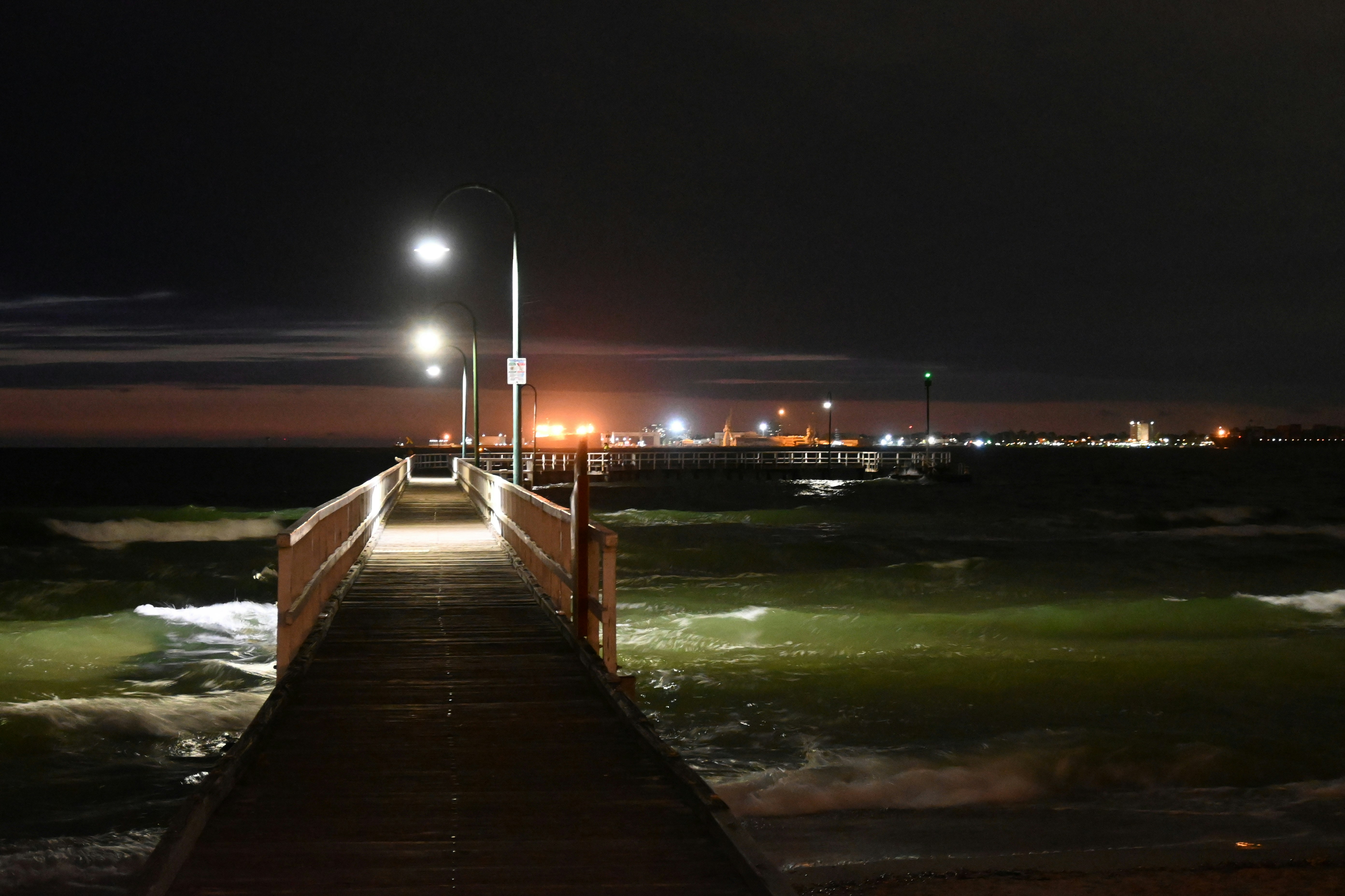 a pier at night with the lights on