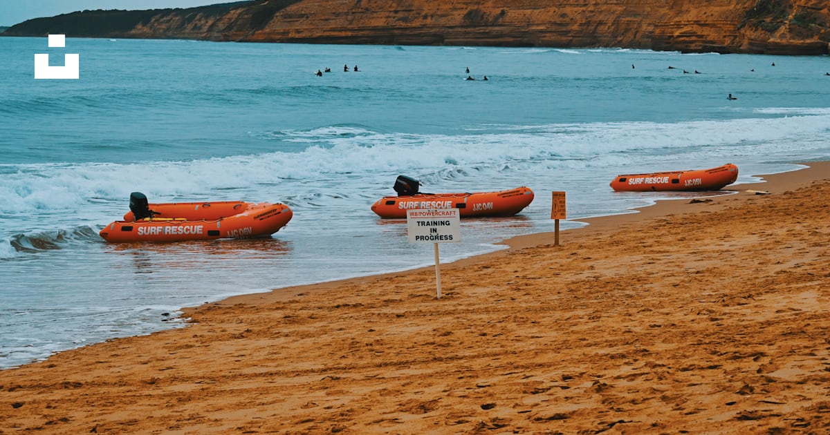 A group of rafts sitting on top of a sandy beach photo – Free Jan juc ...