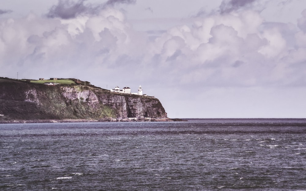 a large body of water with a lighthouse on top of it