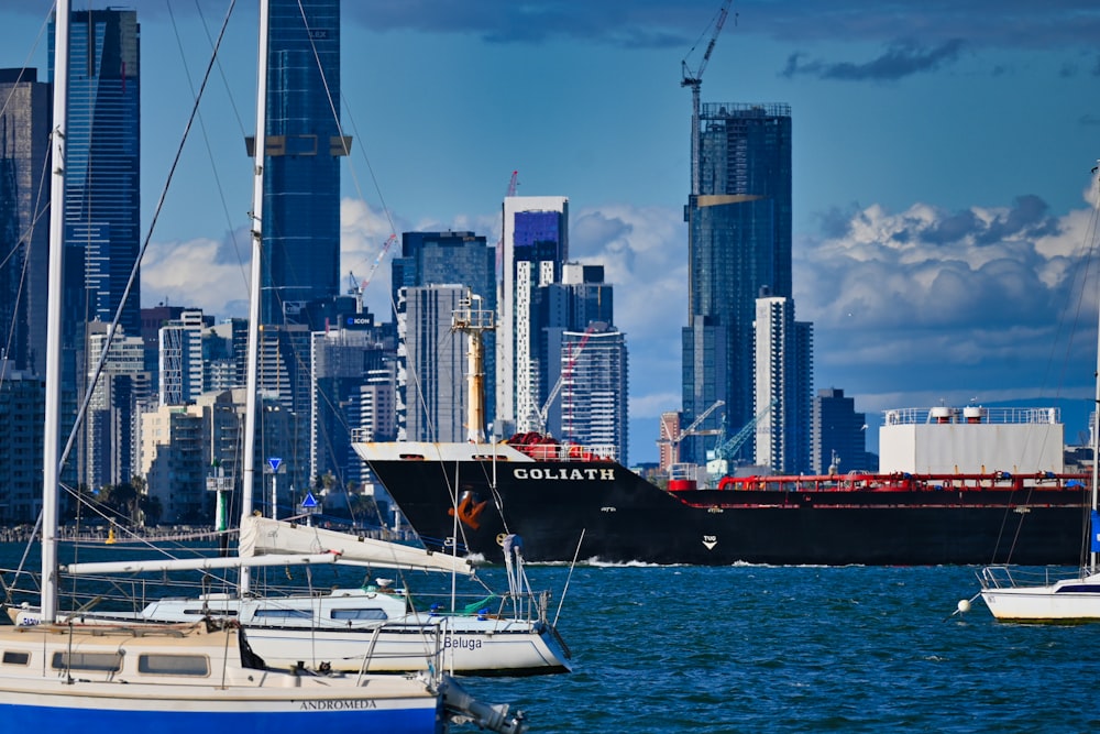 a large boat in the water with a city in the background