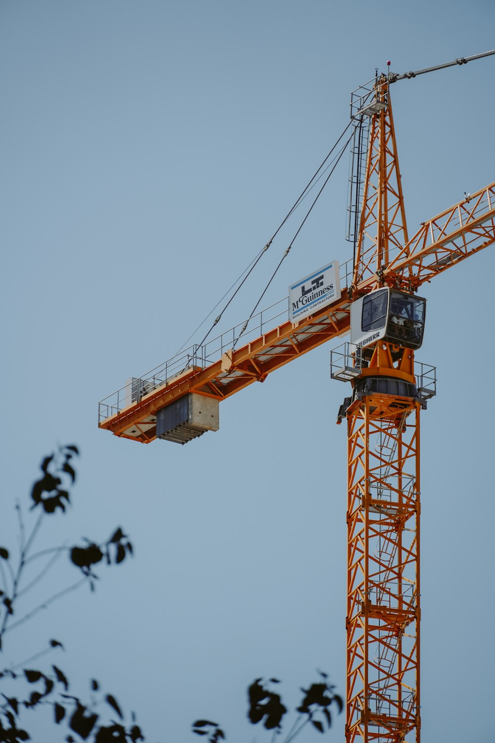 a yellow crane with a blue sky in the background